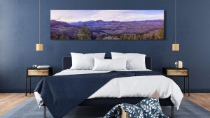 landscape art in a bedroom with blue wall